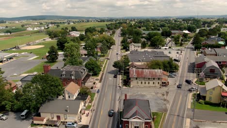 reverse aerial dolly shot of intercourse, lancaster county, pa traffic and shops