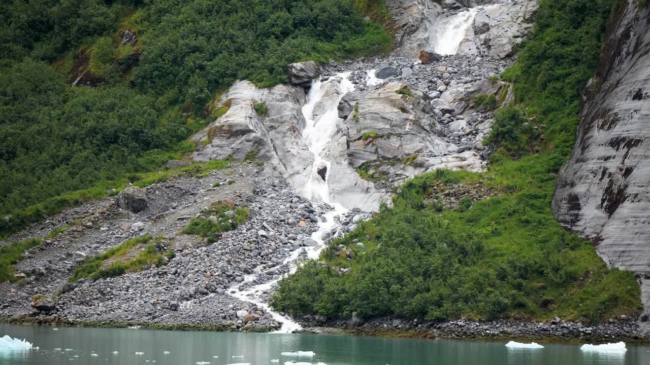Waterfall's pristine glacial meltwater plunges into tidewater at Endicott Arm fjord,Tongass National Forest, Alaska.