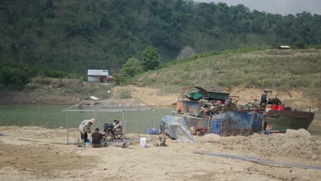 workers repairing a boat on the riverbank