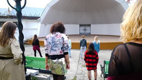 women watching a performance on an outdoor stage