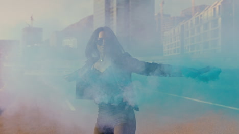 woman dancing with blue smoke bomb in city young rebellious girl celebrating creative expression with dance in street slow motion