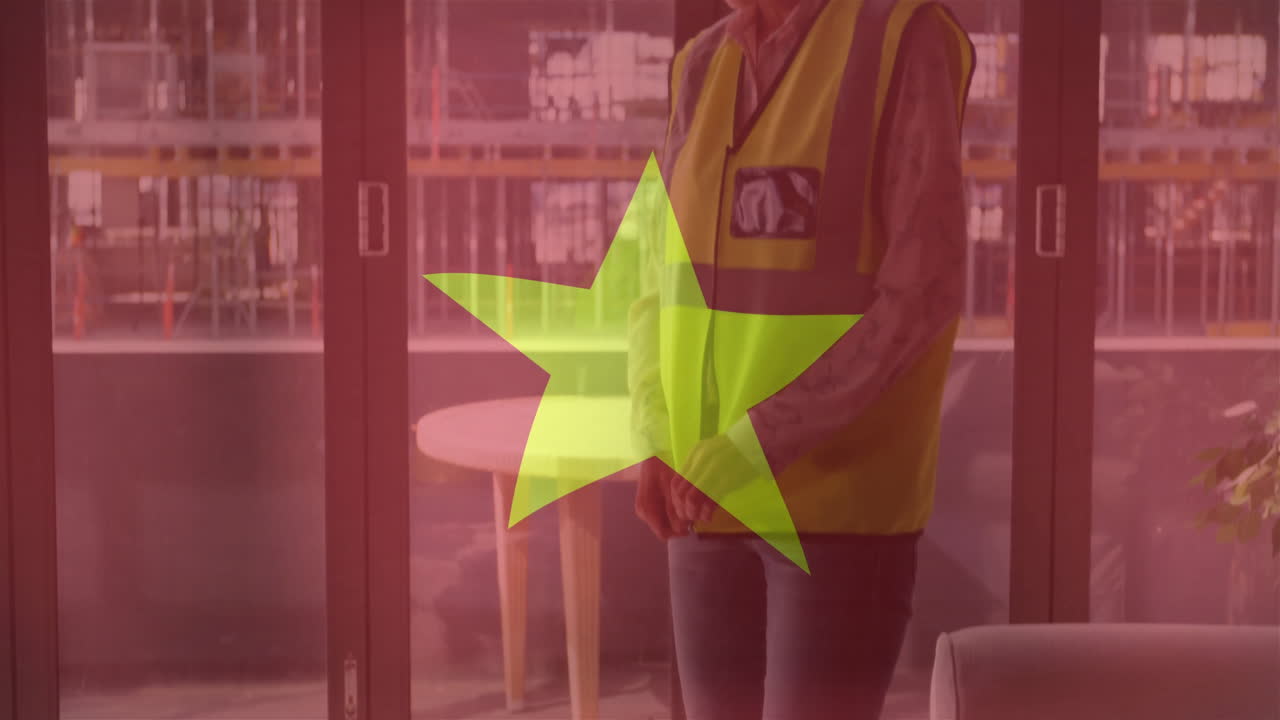 In office, person wearing safety vest with large green star animation overlay
