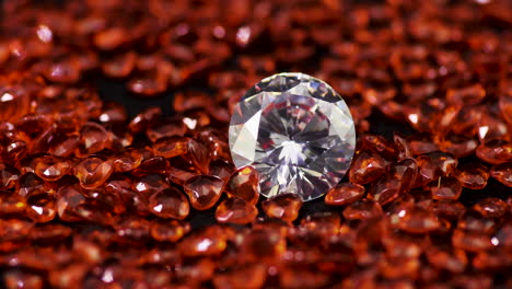 real brilliant-cut shining diamond surrounded by the heart-shaped rubies on the turntable rotating clockwise close-up - highly valuable and expensive gemstones for fashion and weddings