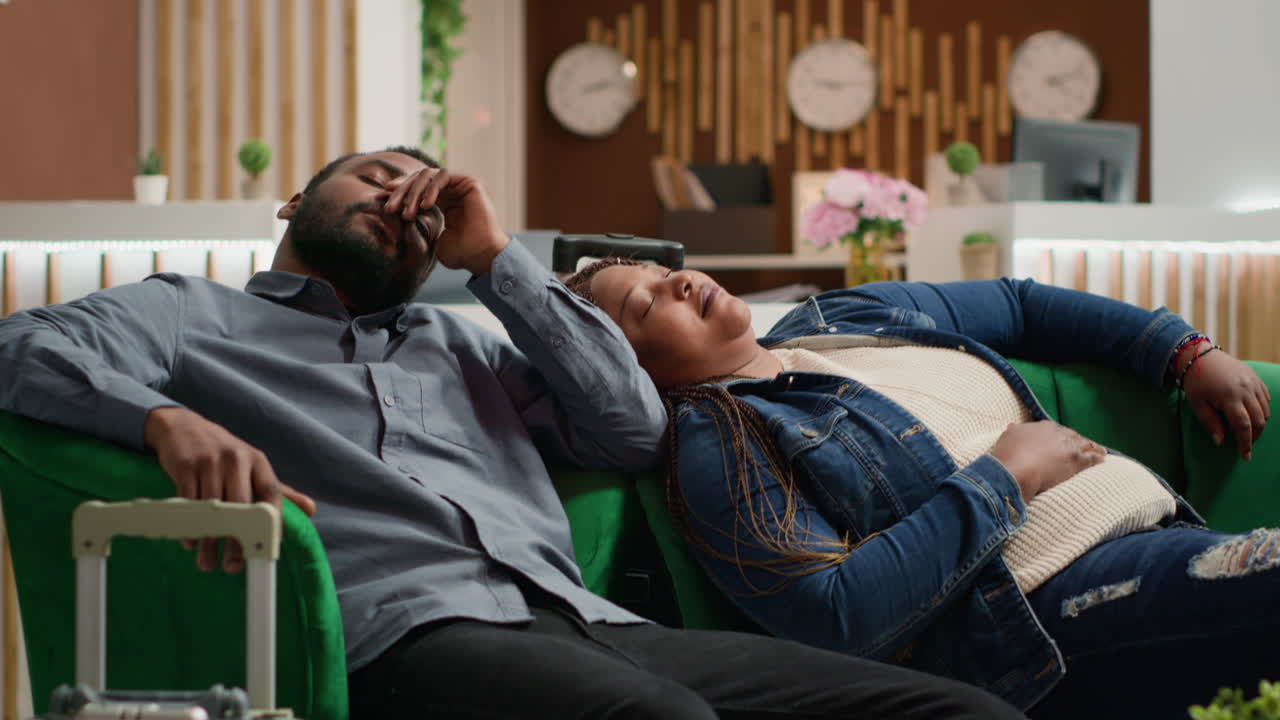 Tired sleepy couple sleeping on couch