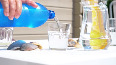 Slow-motion-shot-of-a-fresh-drink-being-poured-with-seashells-placed-on-the-table