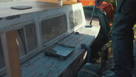 painting deck planking of wooden seaplane tender rolling on with paint roller