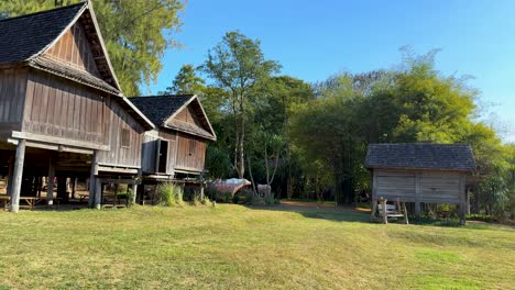 wooden house amidst lush greenery and clear skies