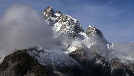 mountain summit over clouds in british columbia, canada - aerial drone shot