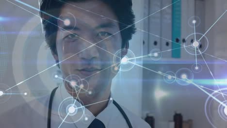 Animation-of-network-of-connetcions-over-asian-male-doctor