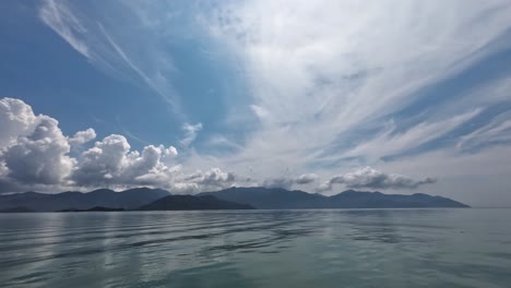 view from boat to monkey island in nha trang vietnam. view the serene sea, distant mountains, and a bird flying by