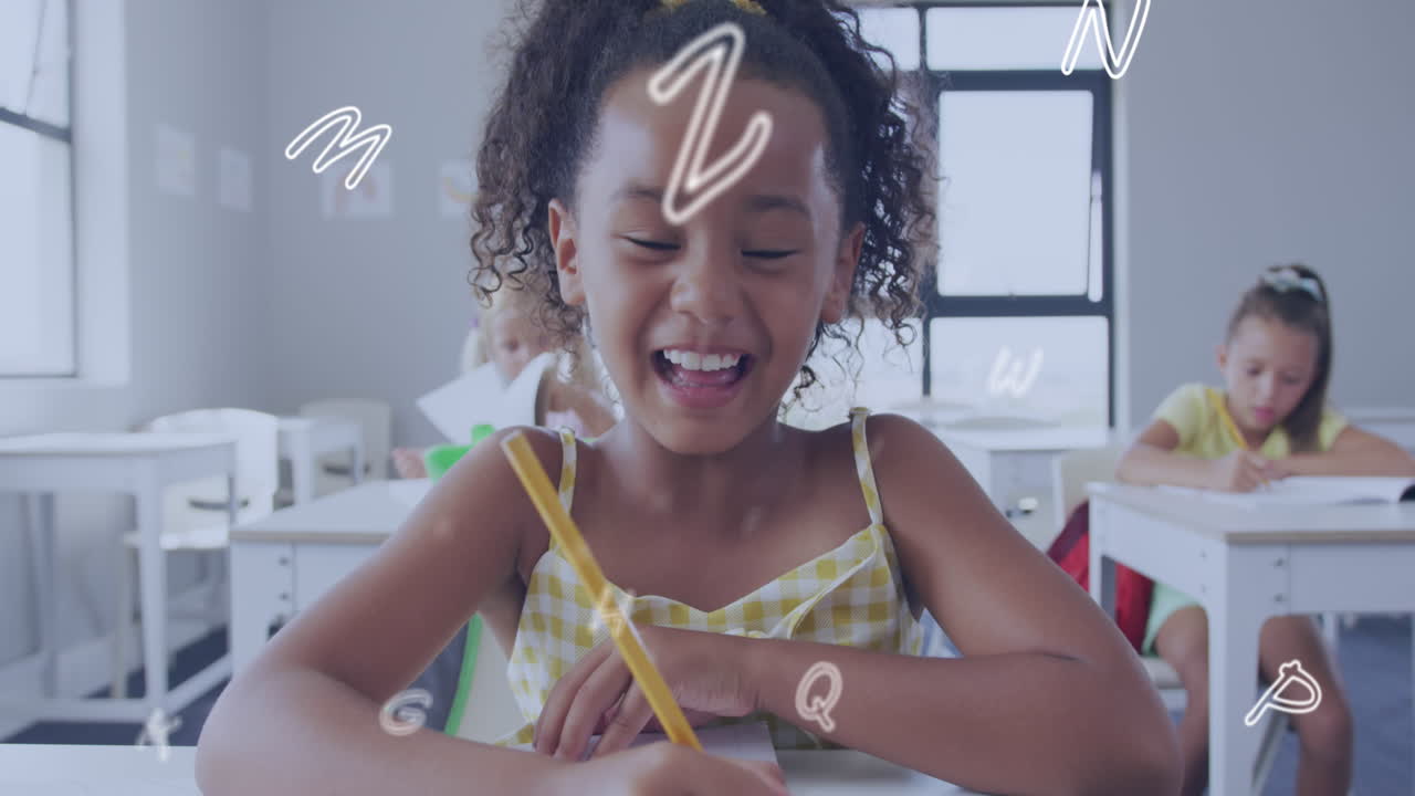 Animation of letters over happy biracial schoolgirl at desk in class