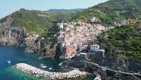 cinque terre boat tour at riomaggiore village in vernazza, la spezia, liguria, italy - aerial 4k pedestal