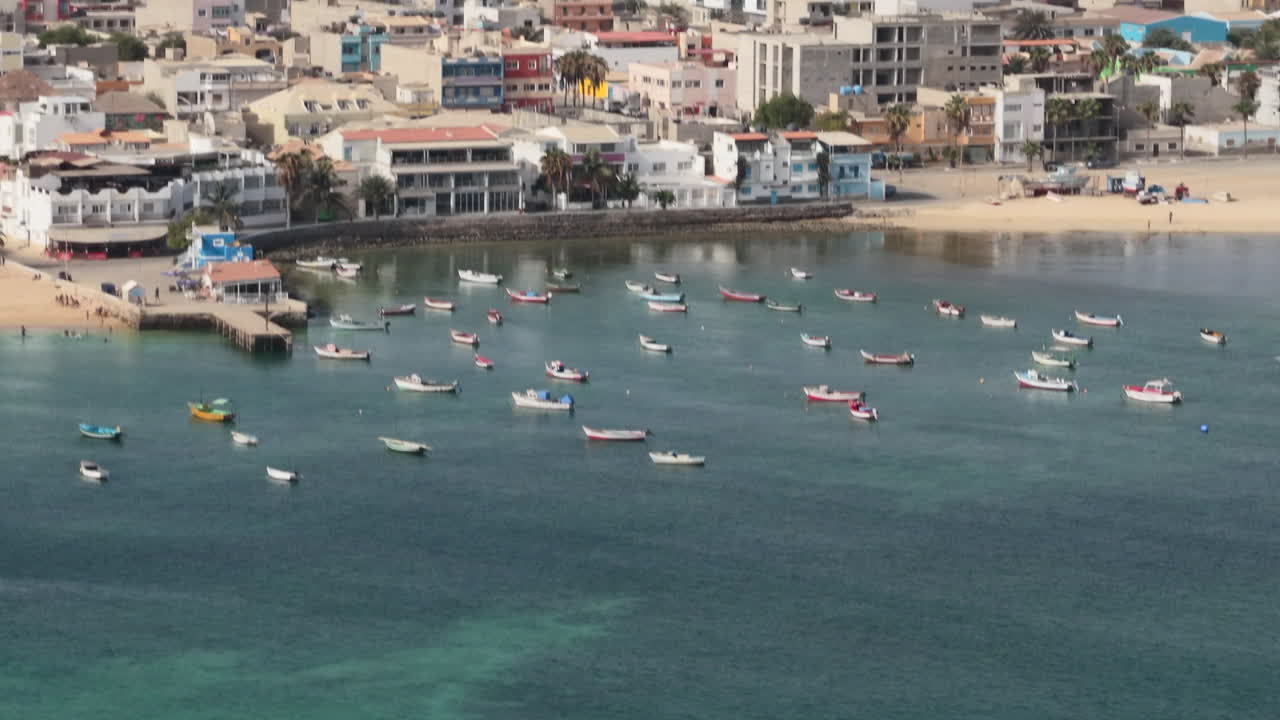 Nice close-up view of the city of Sal Rei, luxury yachts and fishermen boats moored in the port, Old city with many colorful house,Boa Vista, Cape Verde