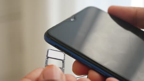 inserting a sim card into a smartphone