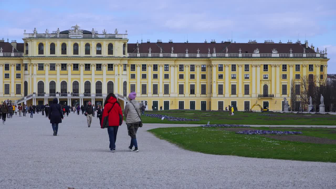 People walking in front of Schönbrunn Palace and gardens in Vienna, Austria