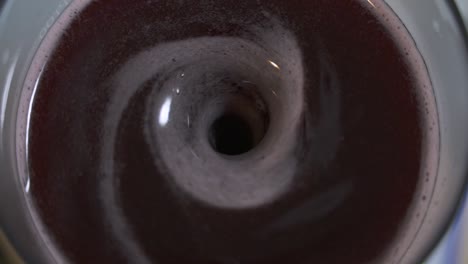 swirling vortex of wine mixing and degassing