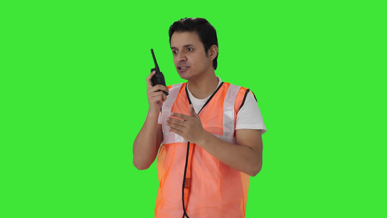Angry Indian airport ground staff worker shouting on walkie talkie Green screen