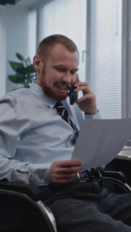 businessman in wheelchair on phone call