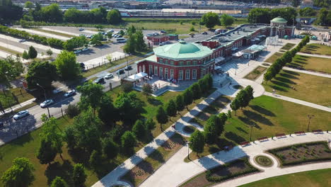 aerial view of a city park with a building and train station