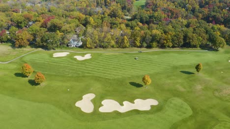 fixed aerial shot of beautiful golf course in fall