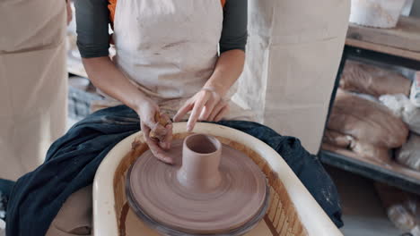 Pottery,-group-and-teacher-mold-clay-in-studio