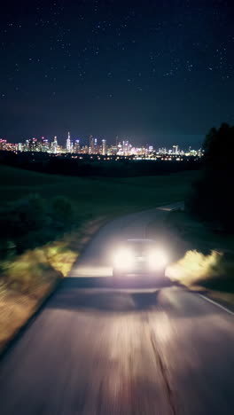 night drive through countryside towards city