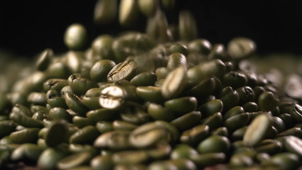 Raw Green Coffee Beans Falling onto a Pile