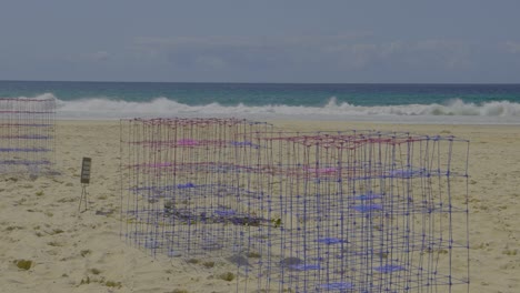 colorful wire sculpture on sandy beach