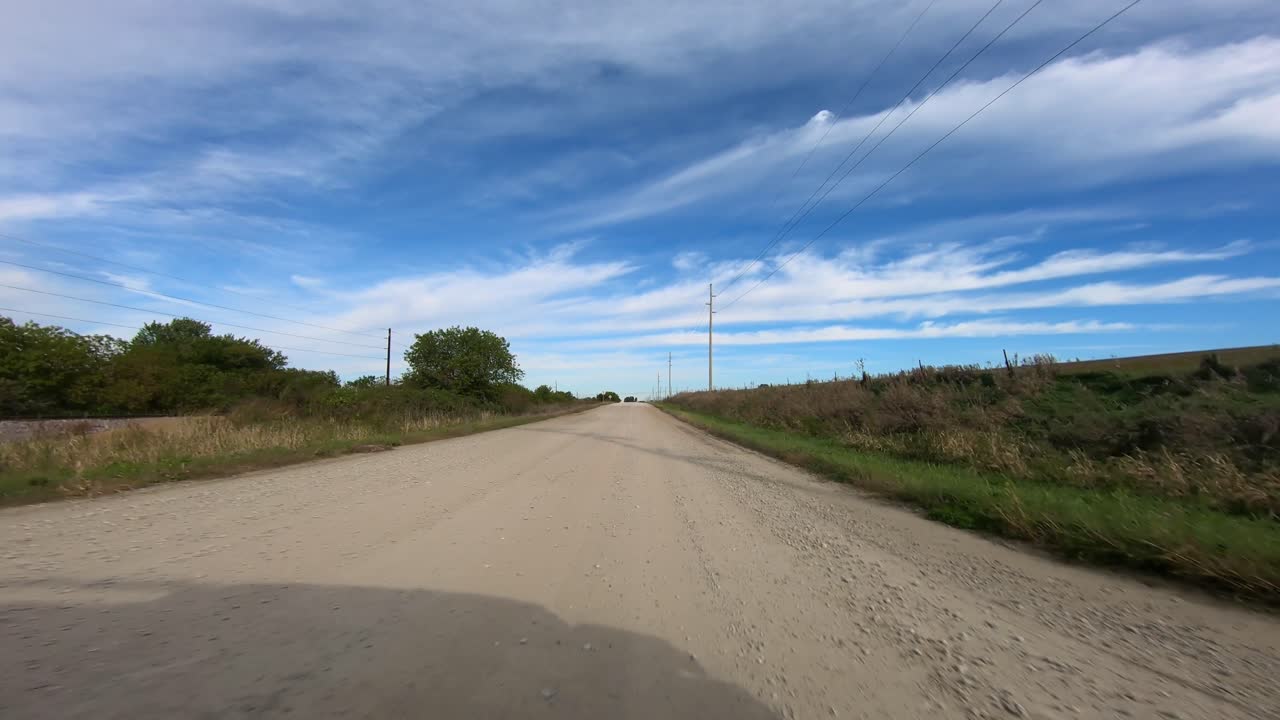 POV through driver's window while driving through rural Iowa