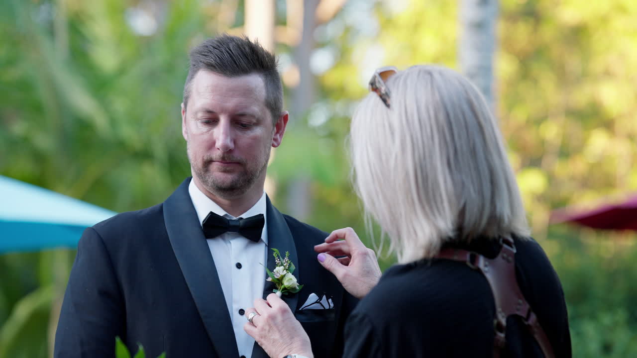 Nervous Groom Having Buttonhole Boutonniere Arranged By Mother On Wedding Day, 4K Resolution Slow Motion