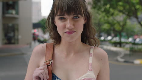 portrait of beautiful cute young woman looking pensive innocent on urban city sidewalk