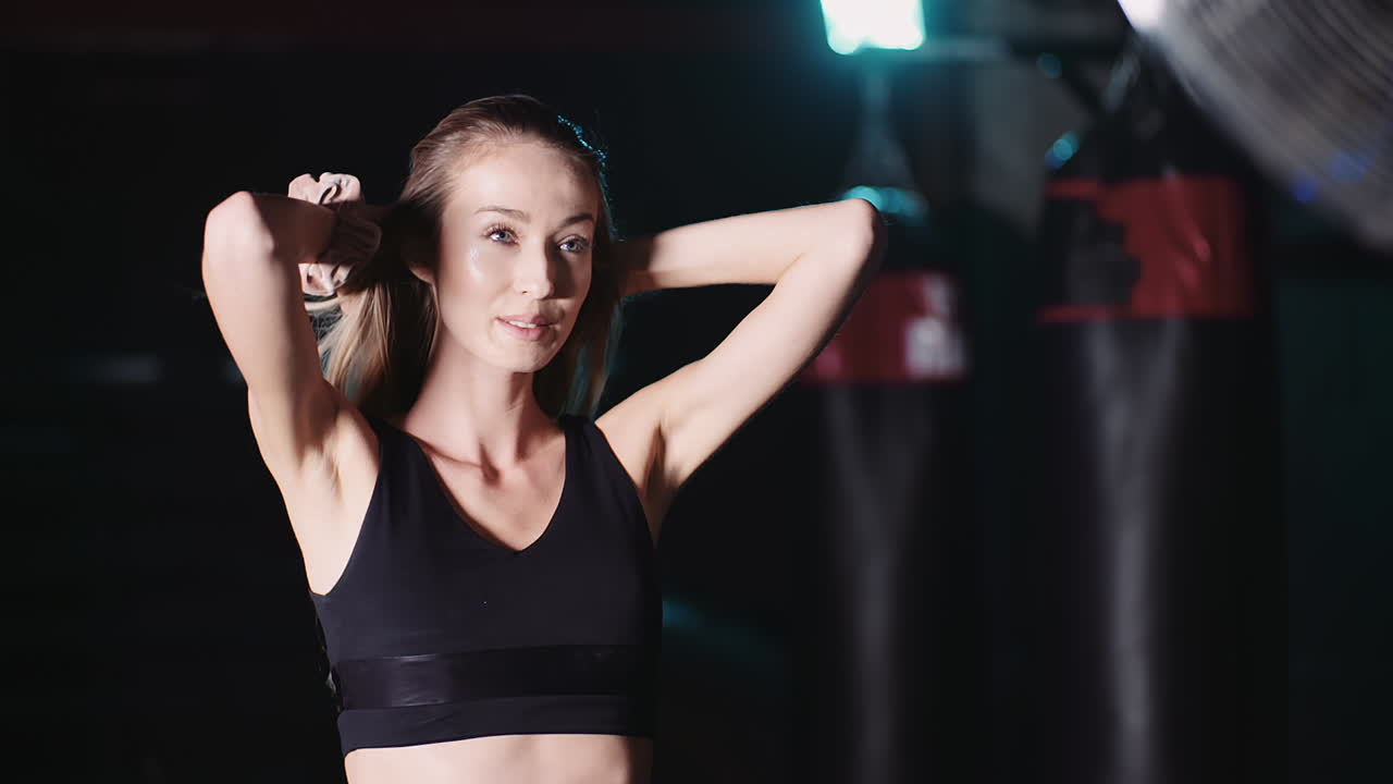 Slow Motion Of Smiling Attractive Female Athlete Moving Hands Through Hair At Health Club 8