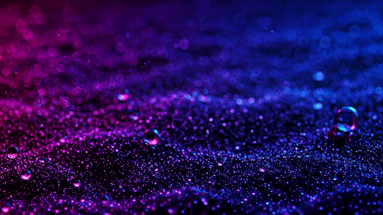 A breathtaking spectacle unfolds as vibrant droplets shimmer and glisten beautifully on a colorful surface under the night sky