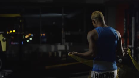 man jumping rope in gym at night