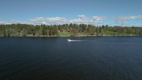 aerial shot following a motor boat on the ocean.