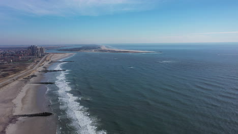 A-high-angle-view-of-an-empty-beach-on-a-beautiful-day-with-a-few-clouds