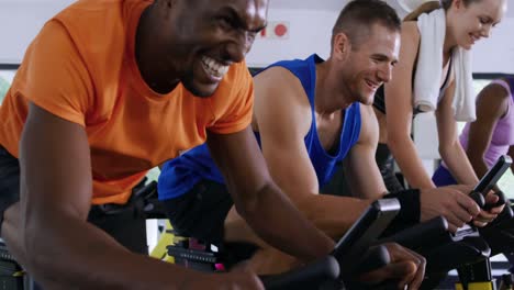 working out on exercise bikes at a gym