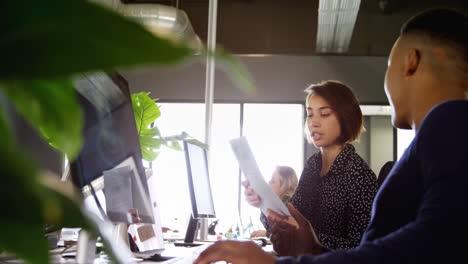 Business-colleagues-discussing-over-document-4k