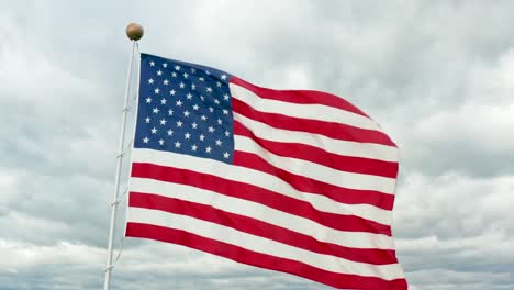 aerial of usa american flag waving in wind