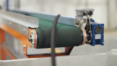 conveyor belt. piece of plastic hose coming off conveyor. hose production line