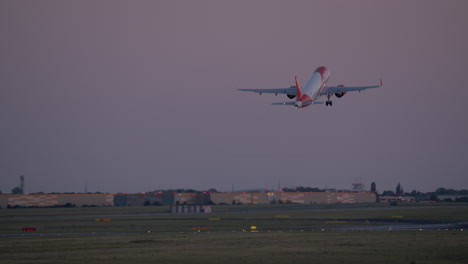 airplane taking off at sunset