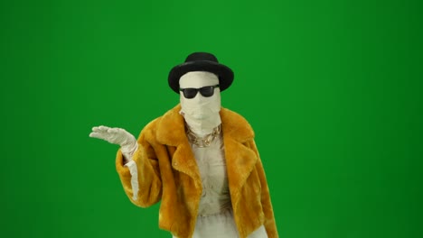 glamorous mummy in orange fur coat hat and sunglasses looks around looking for a victim and raising
