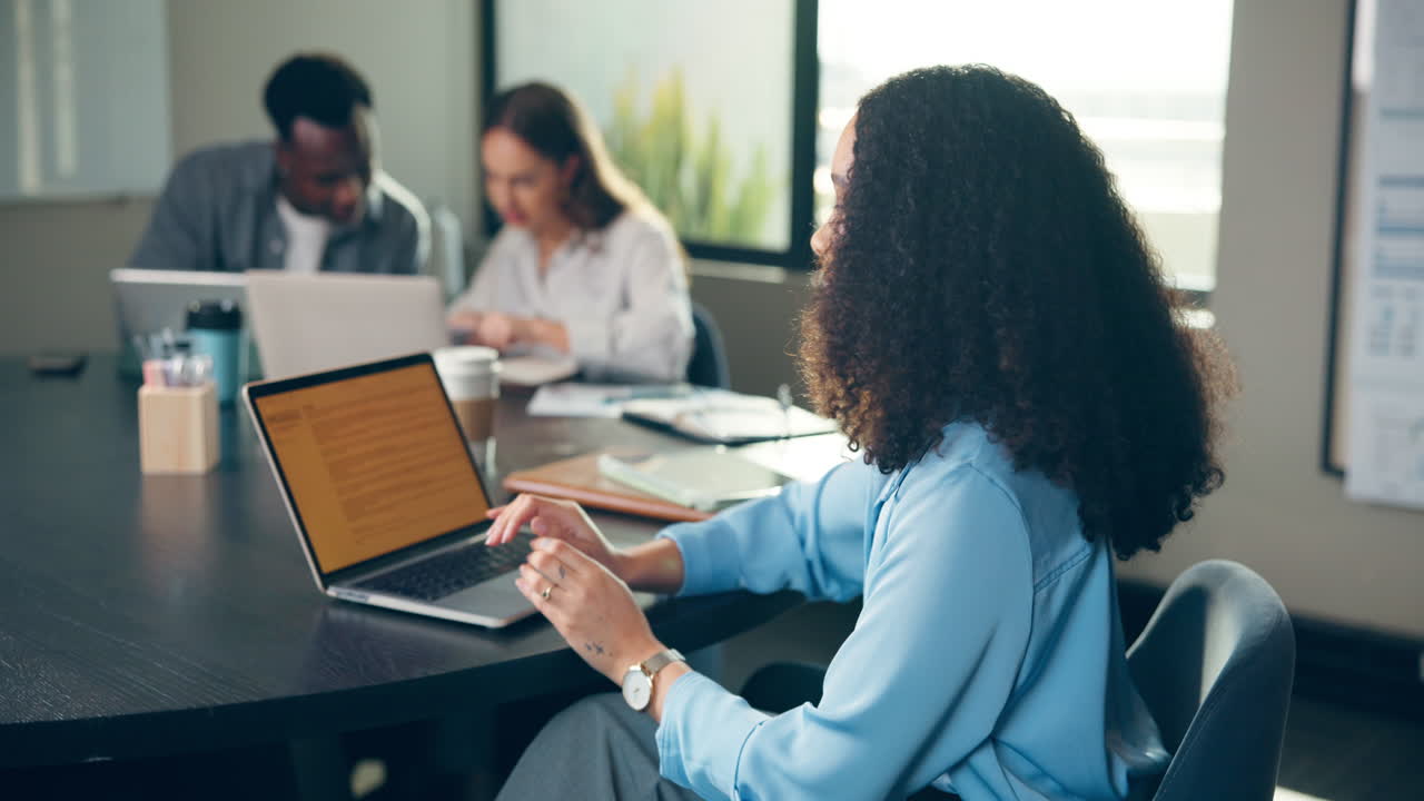 A cheerful businesswoman working with her team in the office