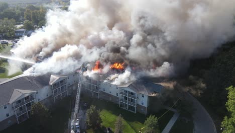 senior living apartments on fire with massive smoke, aerial drone view