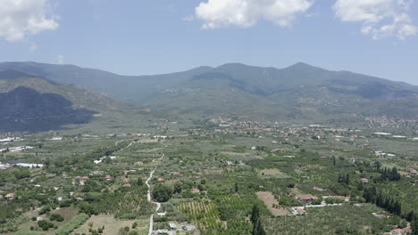 rural flyover of olive grove fields outside a greek mountain village