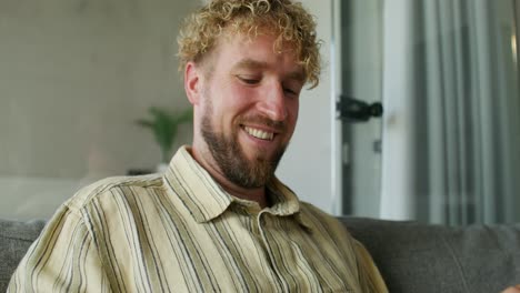man using smartphone on couch