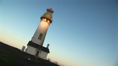 the camera takes an angled shot of this lighthouse on a sunny day