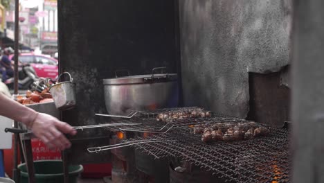 street food vendor grilling sea snails