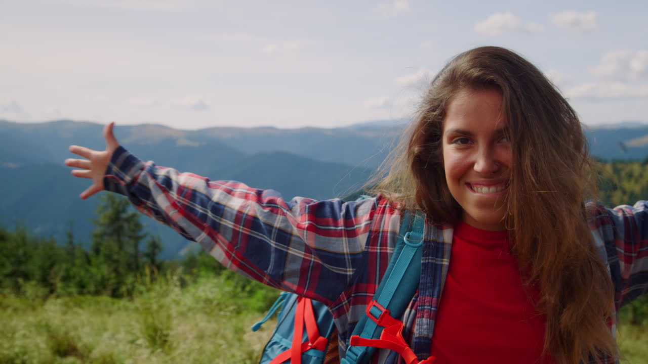 Cheerful woman smiling in mountain hike