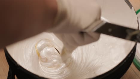 a worker kneads the paint for painting the walls